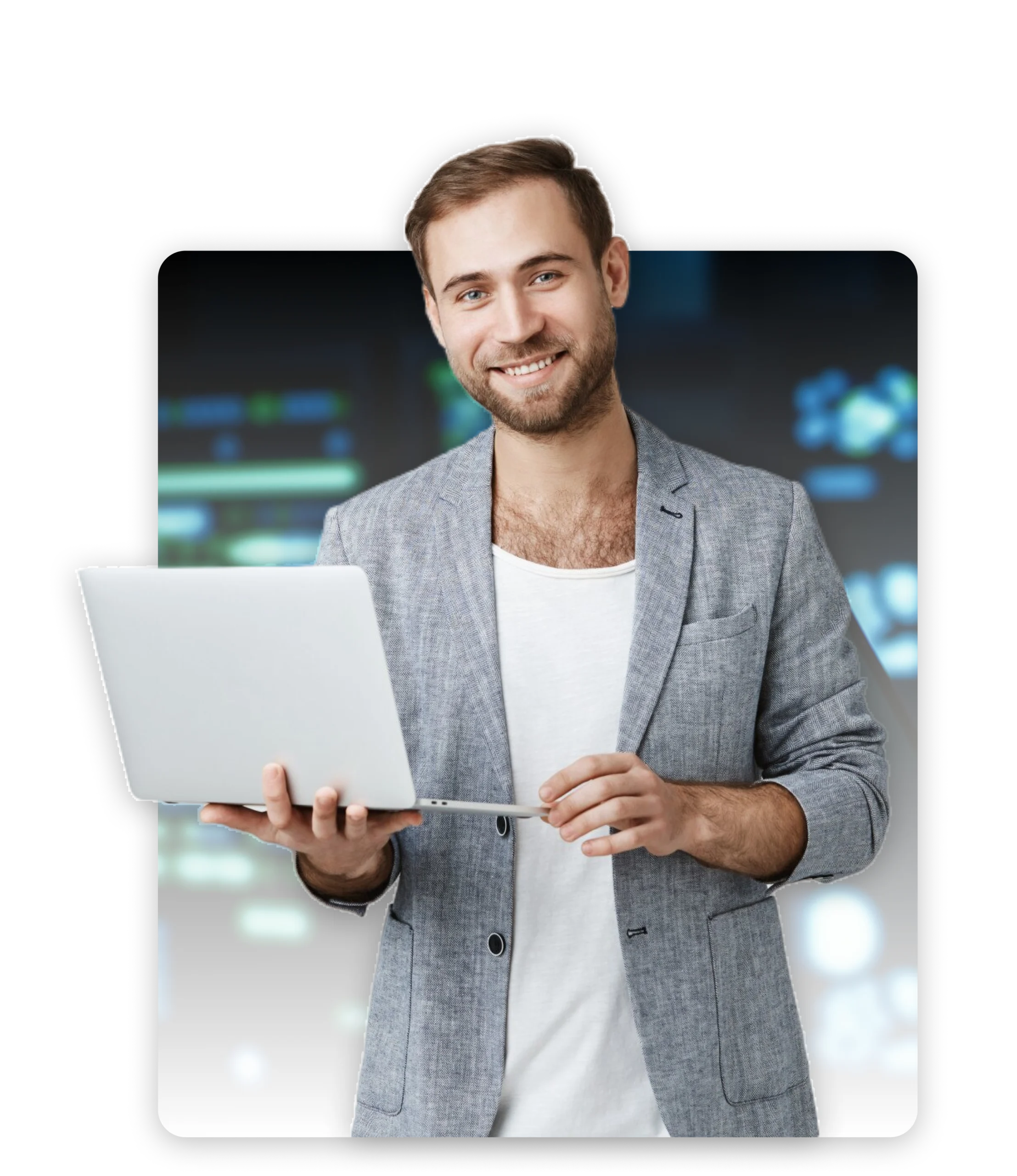 Man standing, holding a laptop and smiling.