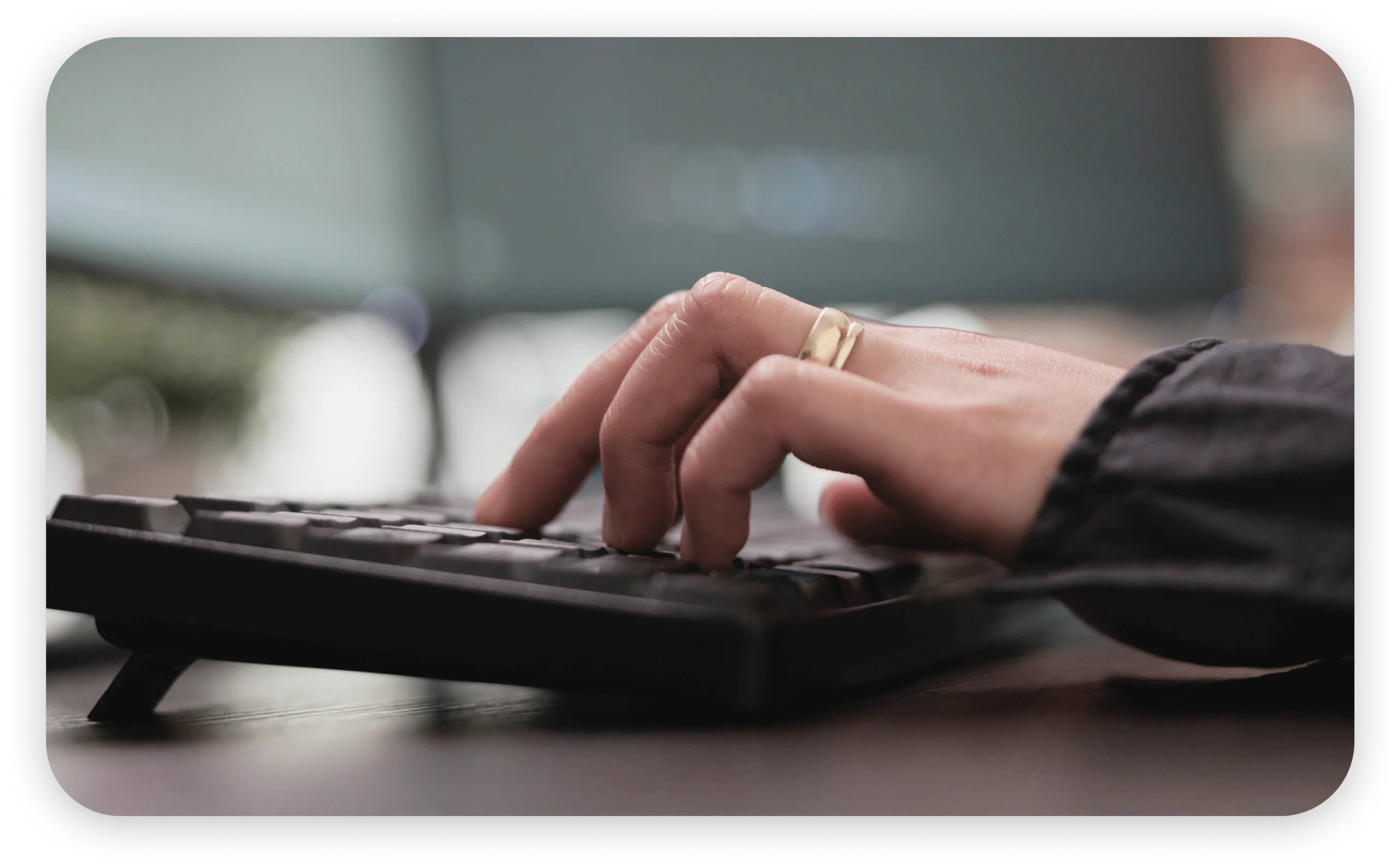 Image of a person's hands typing on a keyboard.